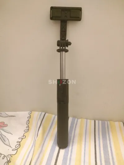 Black extendable selfie stick with Bluetooth button